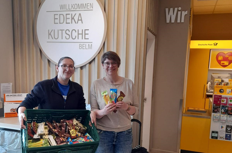 Der Markt in Belm, hier vertreten durch Frau Shapkota, übergibt eine Kiste voll Eis an eine Mitarbeiterin von Spes Viva Trauerland